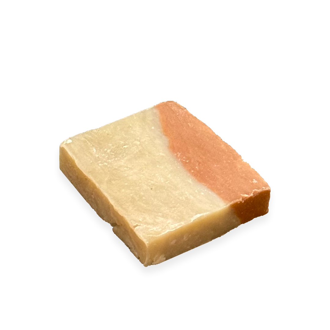 Square handmade soap bar with creamy beige and soft coral layers.