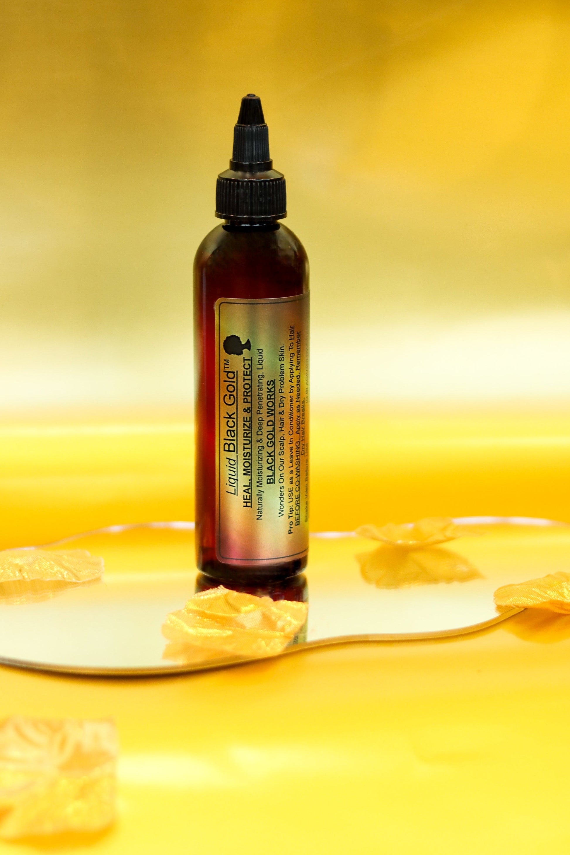 Amber dropper bottle for Black gold work's liquid black gold moisturizing hair oil.