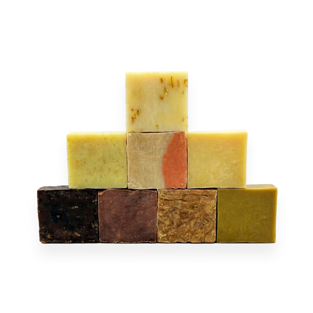 Stack of 8 organic soaps in natural earth tones, crafted for eczema relief and skincare.